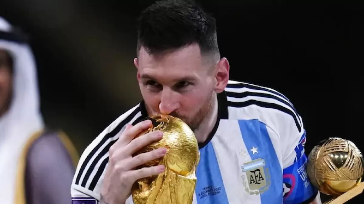 Lionel Messi kissing the World Cup trophy at Lusail Stadium, Qatar last year. 