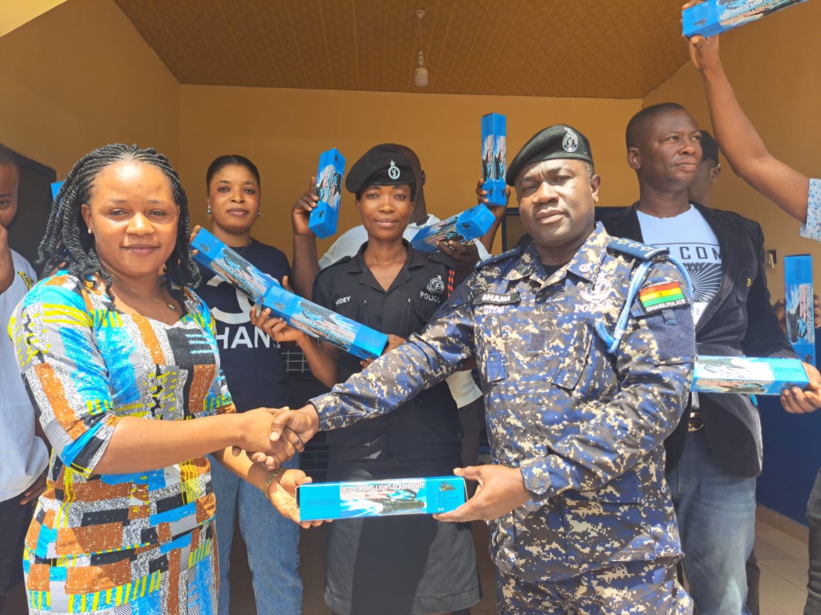 Harriet Aryeh-Lanyo,  NPP MP aspirant for South Dayi presenting the led flashlights to the District Police Commander, DSP CNO Quaye