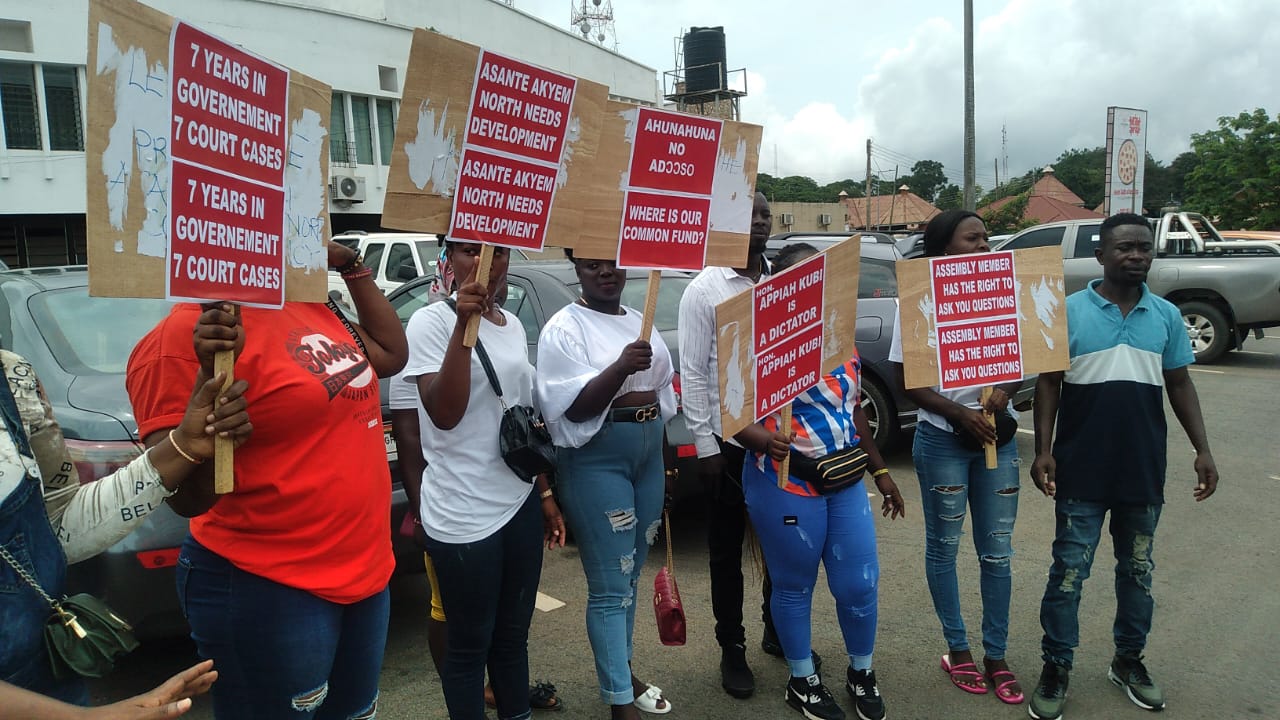 Some youths from Asante Akyem North demonstrating with placards at the precincts of the Kumasi High Court last Friday.
