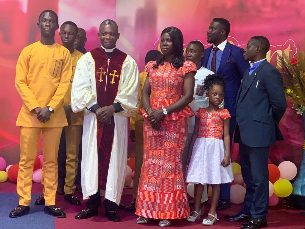Reverend Akwasi Adu-Gyamfi in his official robe as Baptist  Minister for New Life Baptist Church at Dumanafo in a pose with family and Mizpah Baptist Church leader.