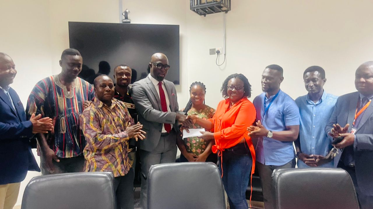 Ms Ophelia Samaaba Prempeh-Kessie, administrator of Kumasi Parliament presenting the cash in an envelope to Professor Otchere Addai-Mensah, Chief Executive Officer of KATH during the visit on Tuesday.