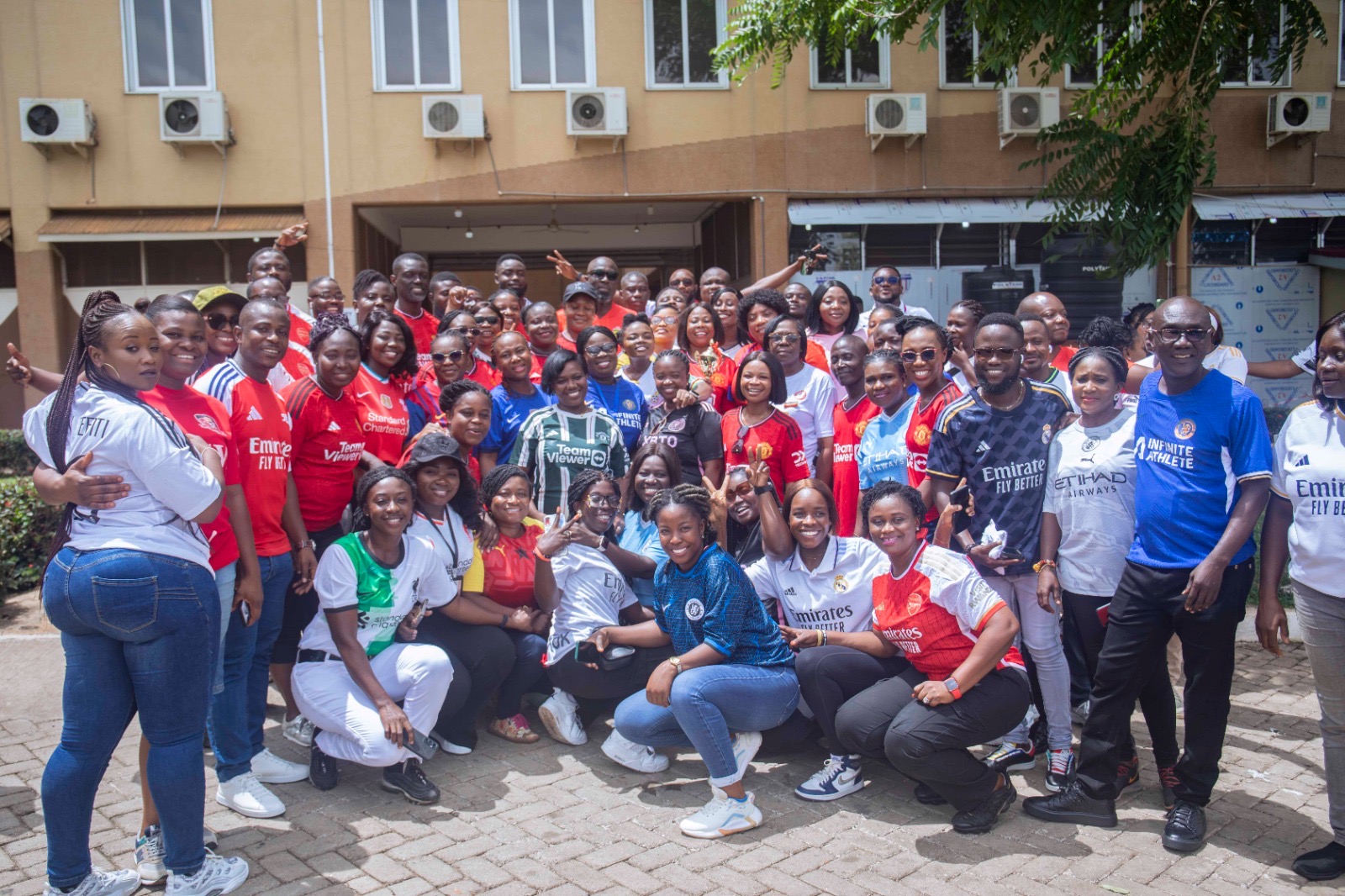 Group pose of management and staff at KATH during rep your Jersey Day at the medical facility