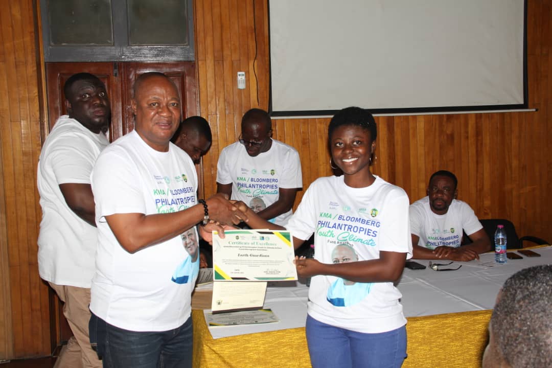 Kumasi Mayor, Hon Samuel Pyne presenting a certificate, cheque and a letter of authorisation to Rodeline Adwoa Saah Asare Darko, leader of Earth Guardians Group at the KMA conference hall on Wednesday morning.